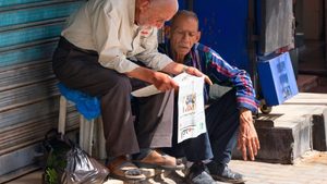 Men in Amman, Jordan reading a newspaper. Publications are under financial pressure in the absence of a big subsidising owner