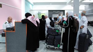 Syrian pilgrims queue at Damascus airport on their way to visit Saudi Arabia in June