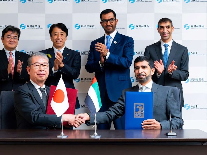 Kazuhiko Amakawa, deputy governor of JBIC and Khaled Al Zaabi, Adnoc group CFO sign the agreement in Tokyo