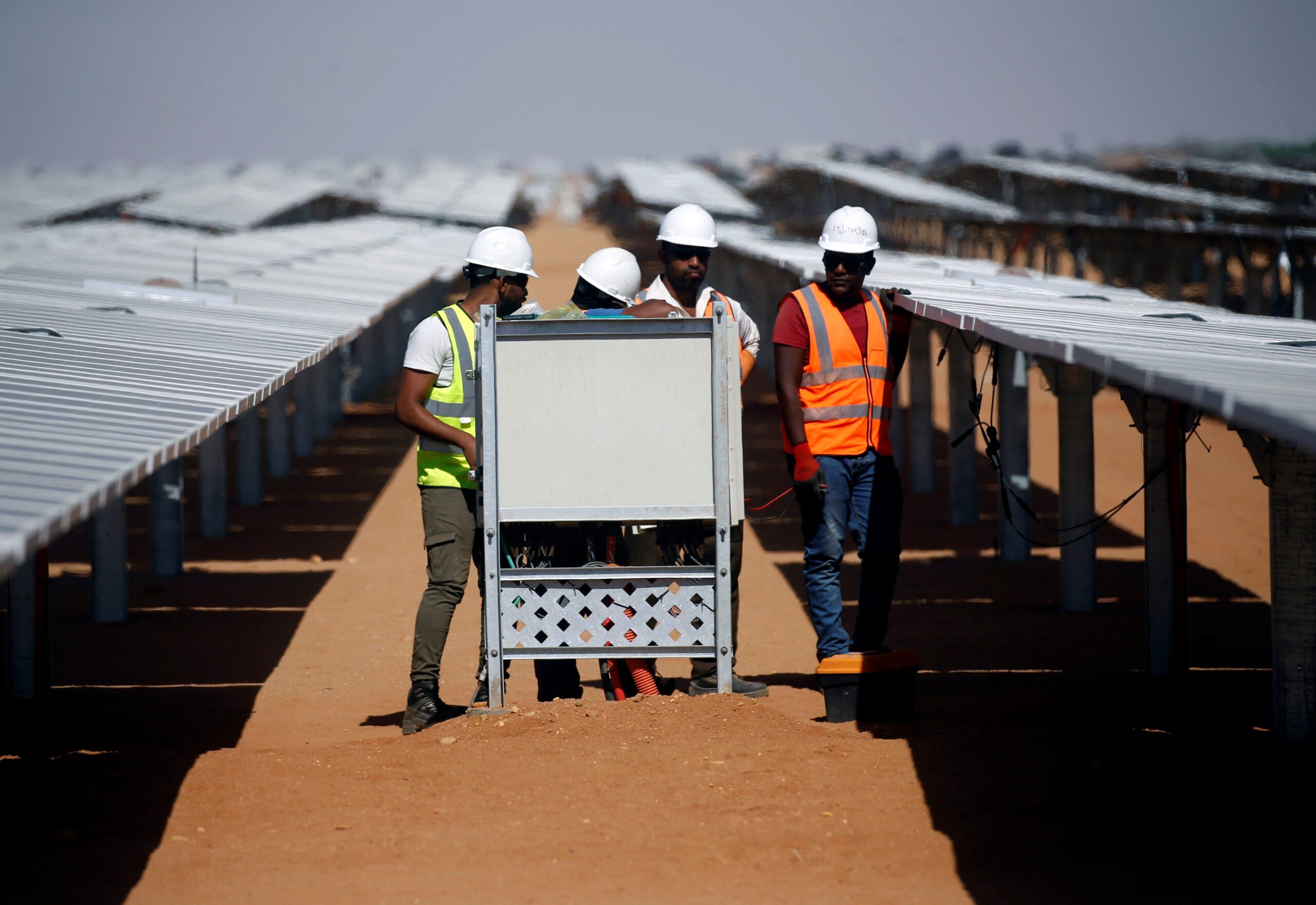 Workers set up photovoltaic solar panels at the Benban plant, which will contribute to Egypt's goal of 58 percent renewable energy by 2040