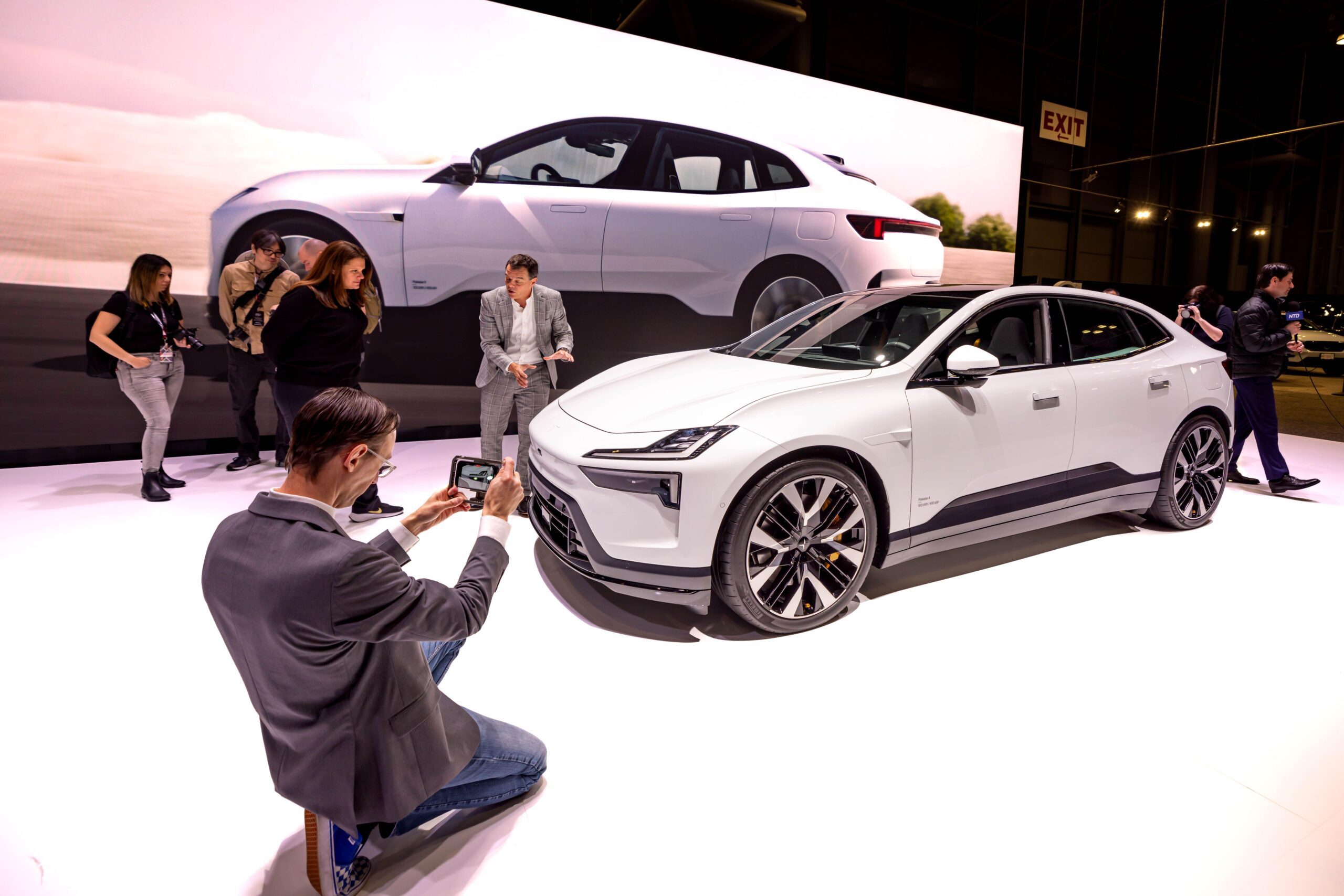 Visitors at the New York International Auto Show look at a Polestar 4 electric SUV. But will it survive the ICE age?