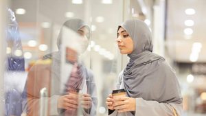 Weaker consumer spending has led retailers to cutting prices in attempt to win customers Woman shopping coffee window