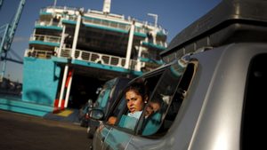 Families queue at the Spanish port of Algeciras to board a ferry to Morocco