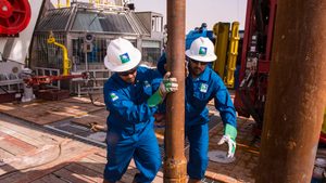 Workers on a Saudi Aramco onshore rig. The company says it remains confident in its forecasts for medium- and long-term demand growth