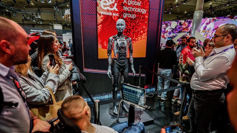 e&'s AI-integrated robot interacts with people at the Mobile World Congress Barcelona 2024. The company's shares have rallied from a four-year low in May