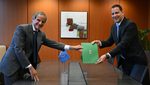 The Saudi ambassador to Slovenia, Abdullah bin Khaled Toula (right), hands Saudi Arabia’s acceptance of the IAEA's privileges and immunities agreement to its director, Rafael Grossi, at the agency’s headquarters in Vienna