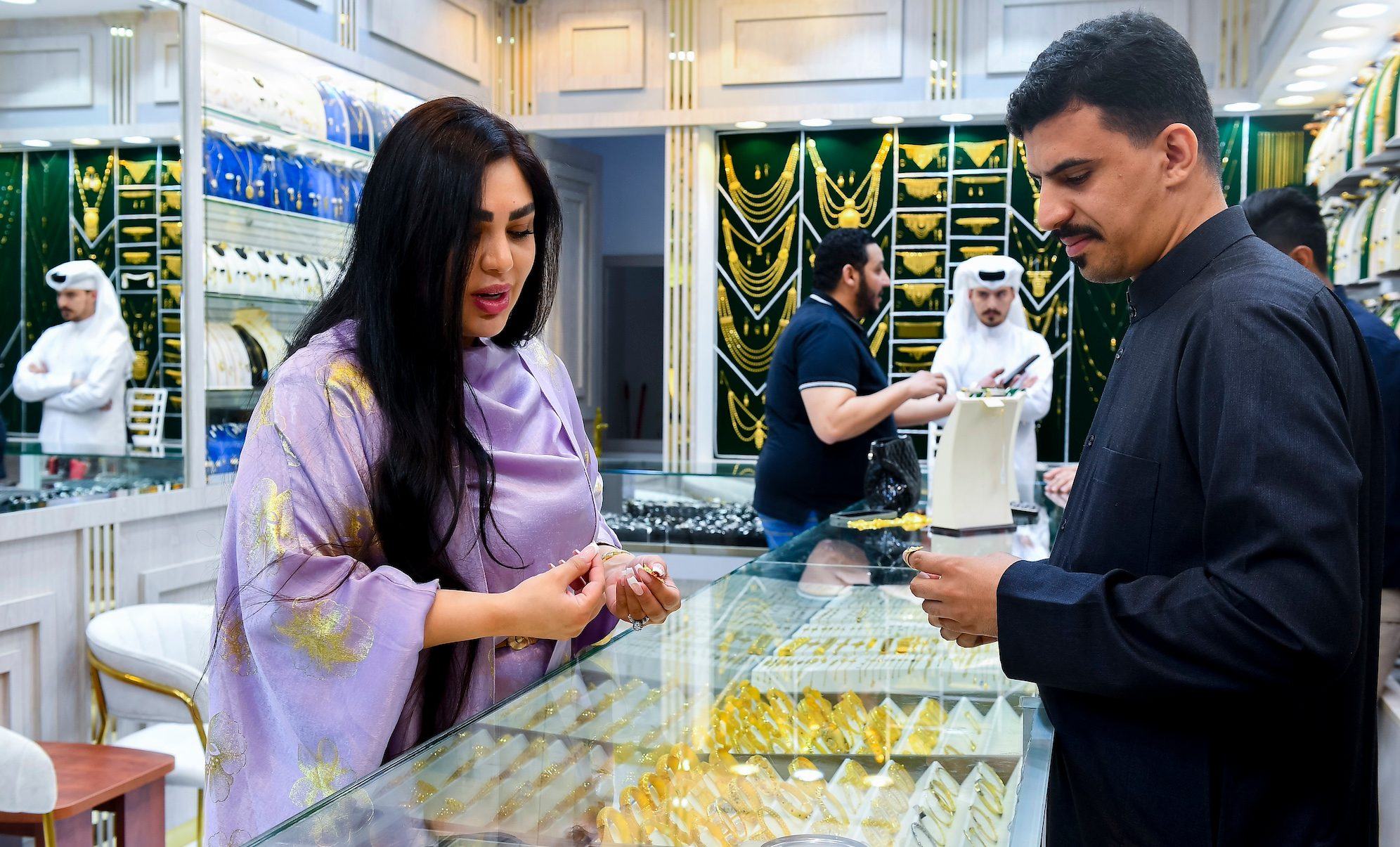 A customer inspects jewellery in Doha. Global demand for jewellery is crumbling under the weight of high prices