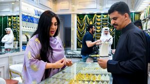 A customer inspects jewellery in Doha. Global demand for jewellery is crumbling under the weight of high prices