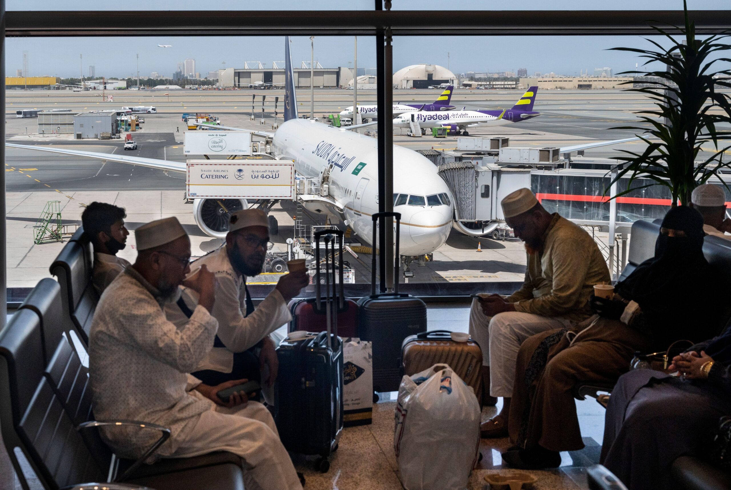 Passengers and a Saudia jet at Jeddah airport. The Jeddah-Riyadh route is the sixth most popular domestic airline route in the world