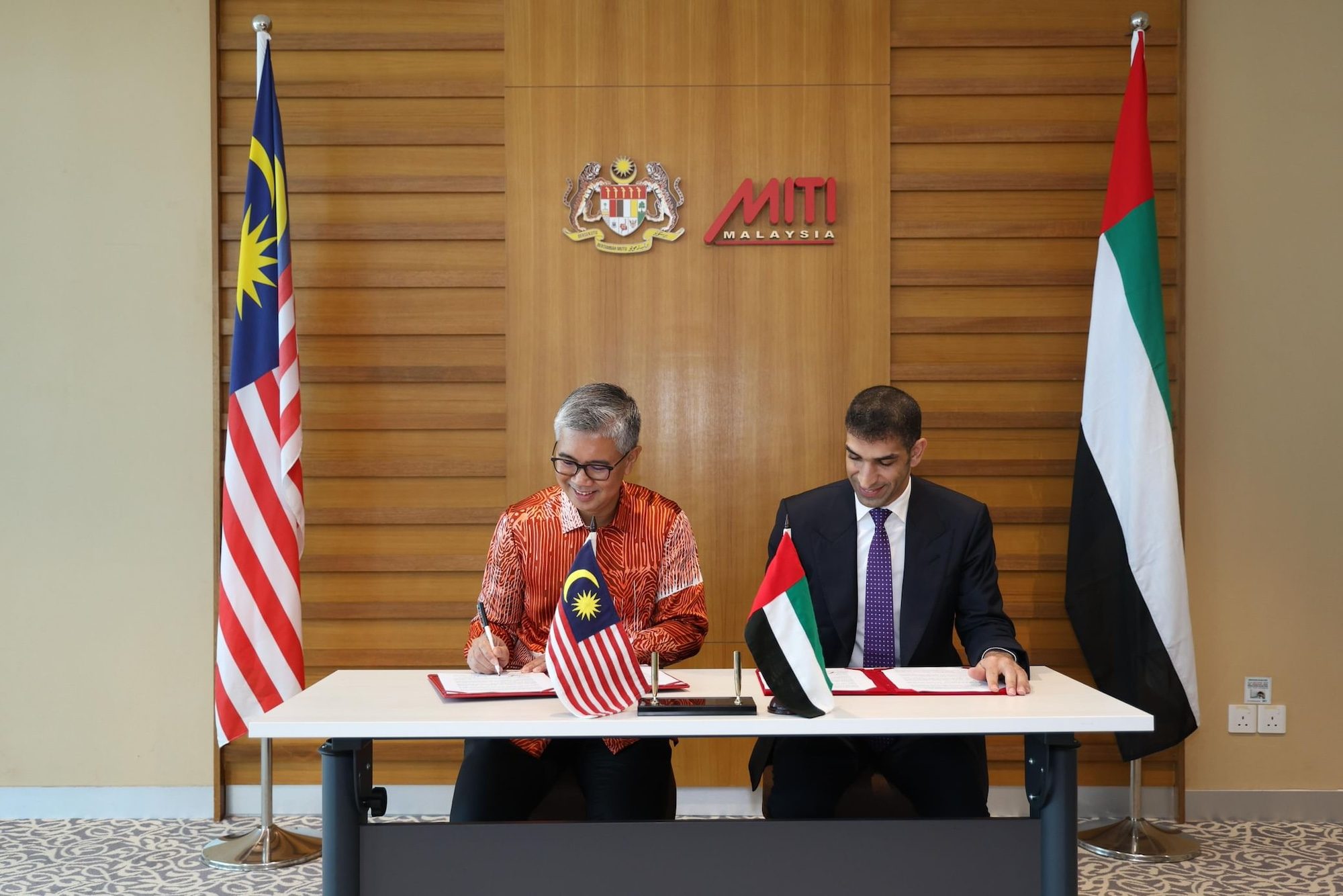 Tengku Zafrul Aziz and Dr Thani bin Ahmed Al Zeyoudi signing the agreement this week
