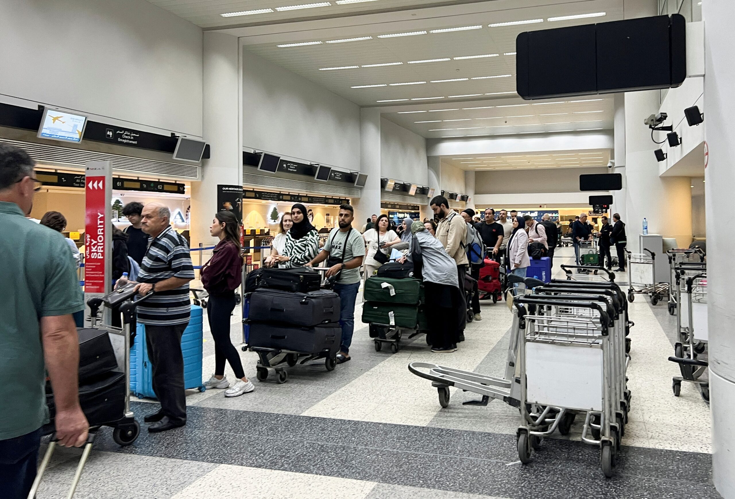 Passengers queue at Beirut-Rafic Al Hariri International Airport. Many airlines have suspended operations to Tel Aviv and Beirut