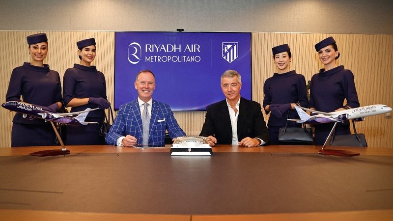 Tony Douglas, CEO of Riyadh Air, seated left, and Miguel Ángel Gil, CEO of Atlético Madrid, seated right, unveil the new name of the football club's stadium