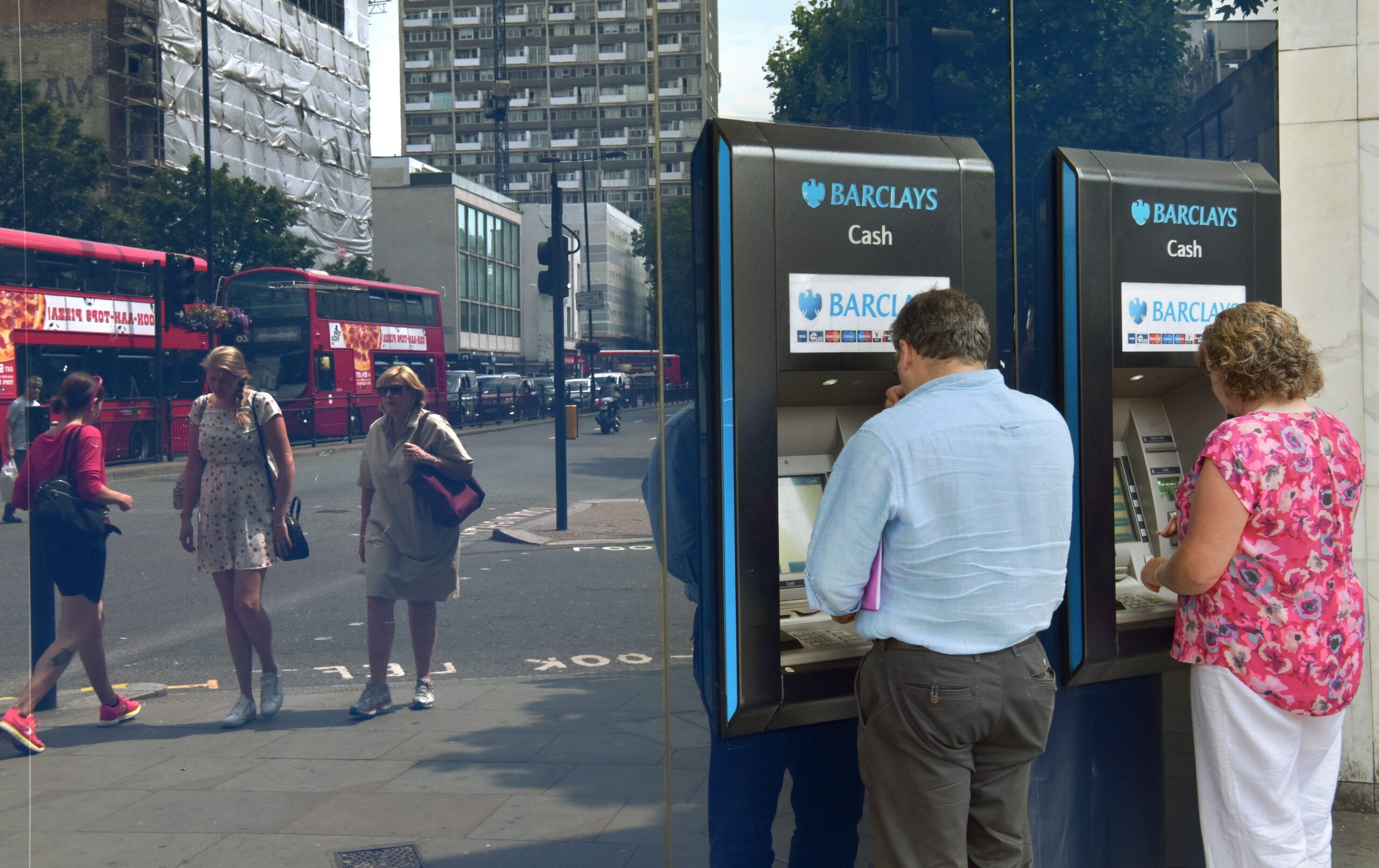 Customers use ATMs at a Barclays branch in London. Qatari investors helped the bank avoid a state bailout