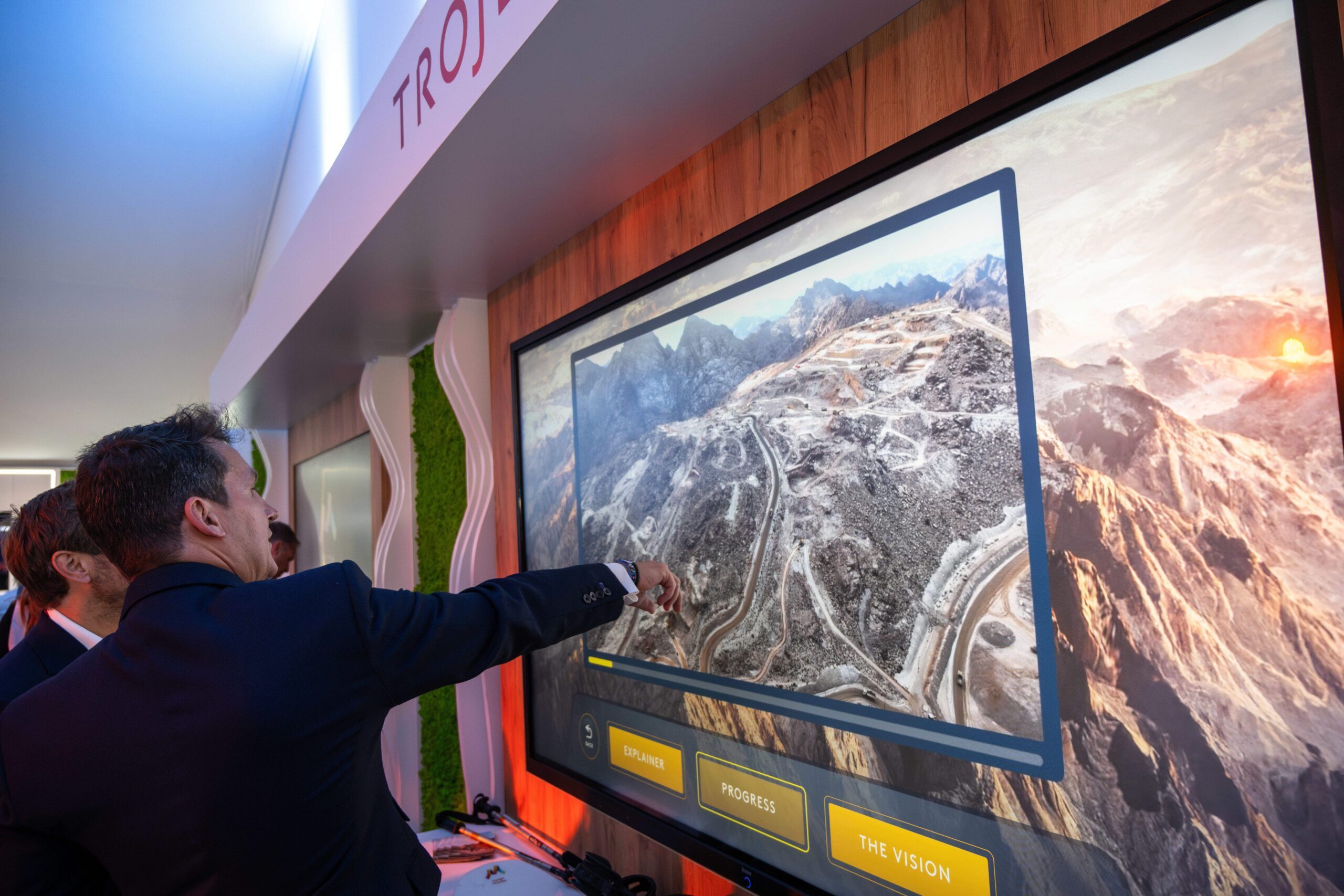 Businessmen watch an on-screen presentation of Saudi Arabia's Trojena project at the Mipim in Cannes.