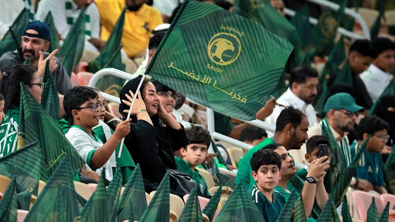 Saudi Arabia fans wave flags before a World Cup qualifier in Jeddah. The country is sole bidder for the 2034 tournament