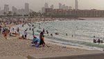 People on Kuwait City's Marina Beach. It is estimated that housing costs in Kuwait absorb one third of an average household's income