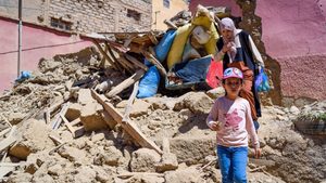 A mother and daughter leave their destroyed house in Amizmiz, Morocco. The EU is to increase its total earthquake aid to €1bn
