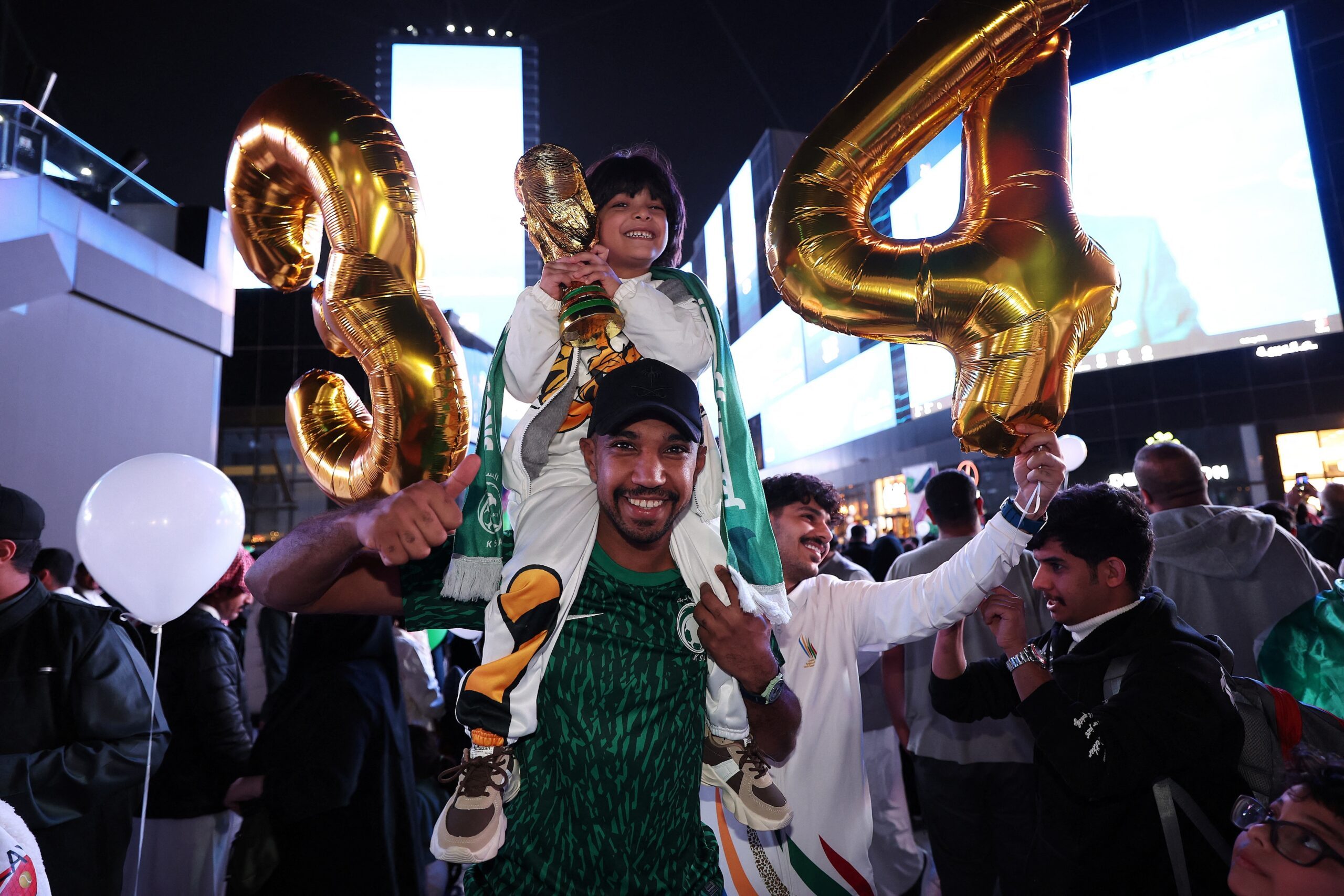 People celebrate after Saudi Arabia is awarded the 2034 World Cup. As well as new stadiums, the country is preparing 134 training centres