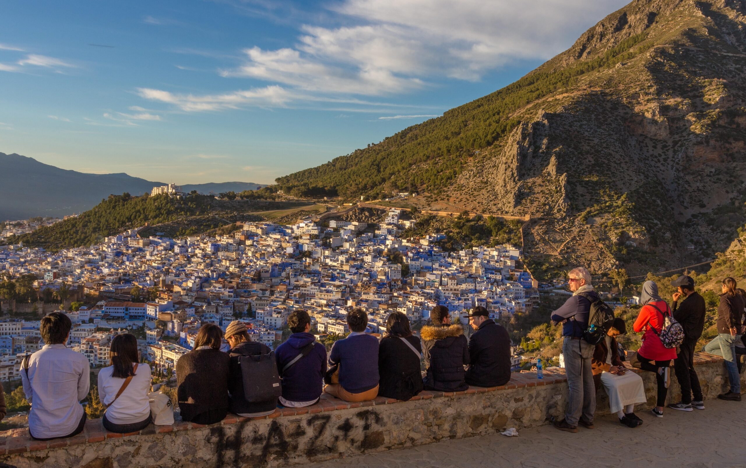 Tourists enjoying the view of Chefchaouen from the Spanish Mosque, northwest Morocco