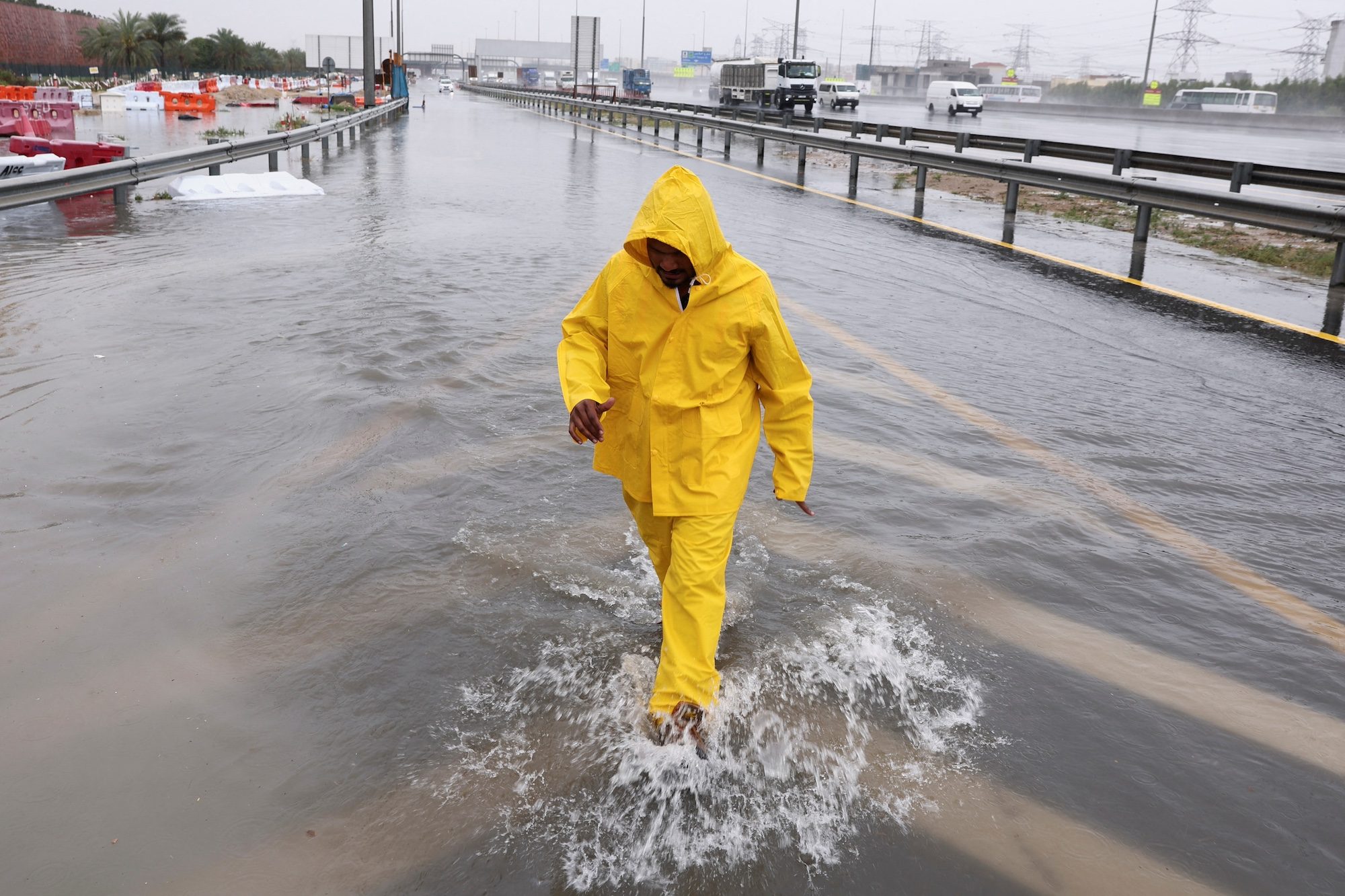 Clothing, Coat, Adult Flooding in April 2024 in the UAE killed five people and cost $1.8-$2.3 billion in property damage