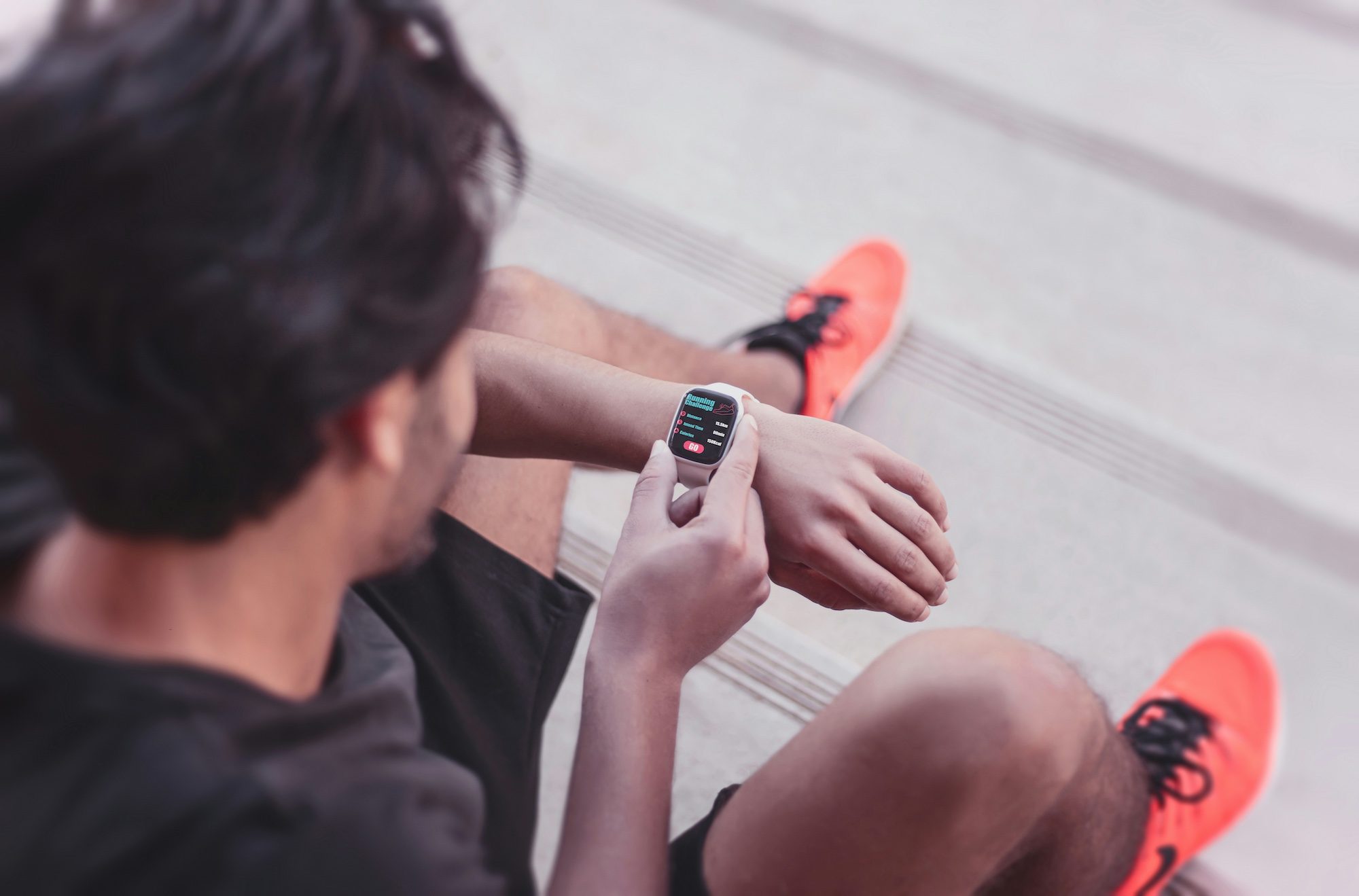A jogger checks his smartwatch. Revibe sells watches, phones and other devices