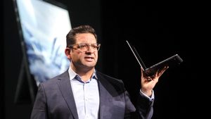 Rahul Tikoo, vice president at chip designer AMD, holds HP's AI-capable Zbook Ultra G1a laptop at CES 2025 in Las Vegas