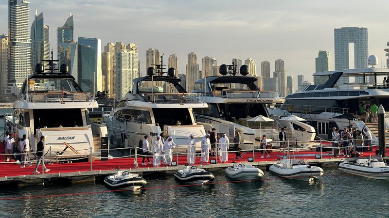 Visitors inspect yachts at Dubai's International Boat Show. The city's economic stability and climate are major draws for the super-rich