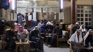 Men gather at Mubarakiya Market in Kuwait City. The country's finance minister says it is 'serious in going ahead with reforms'