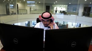 A trader checks the market at the Saudi exchange; Derayah Derayah is considering seeking a valuation of about $2 billion
