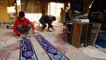 Craftsmen making traditional ceramic tiles in the holy city of Karbala, Iraq. Unemployment stood at around 16.5 percent in 2023