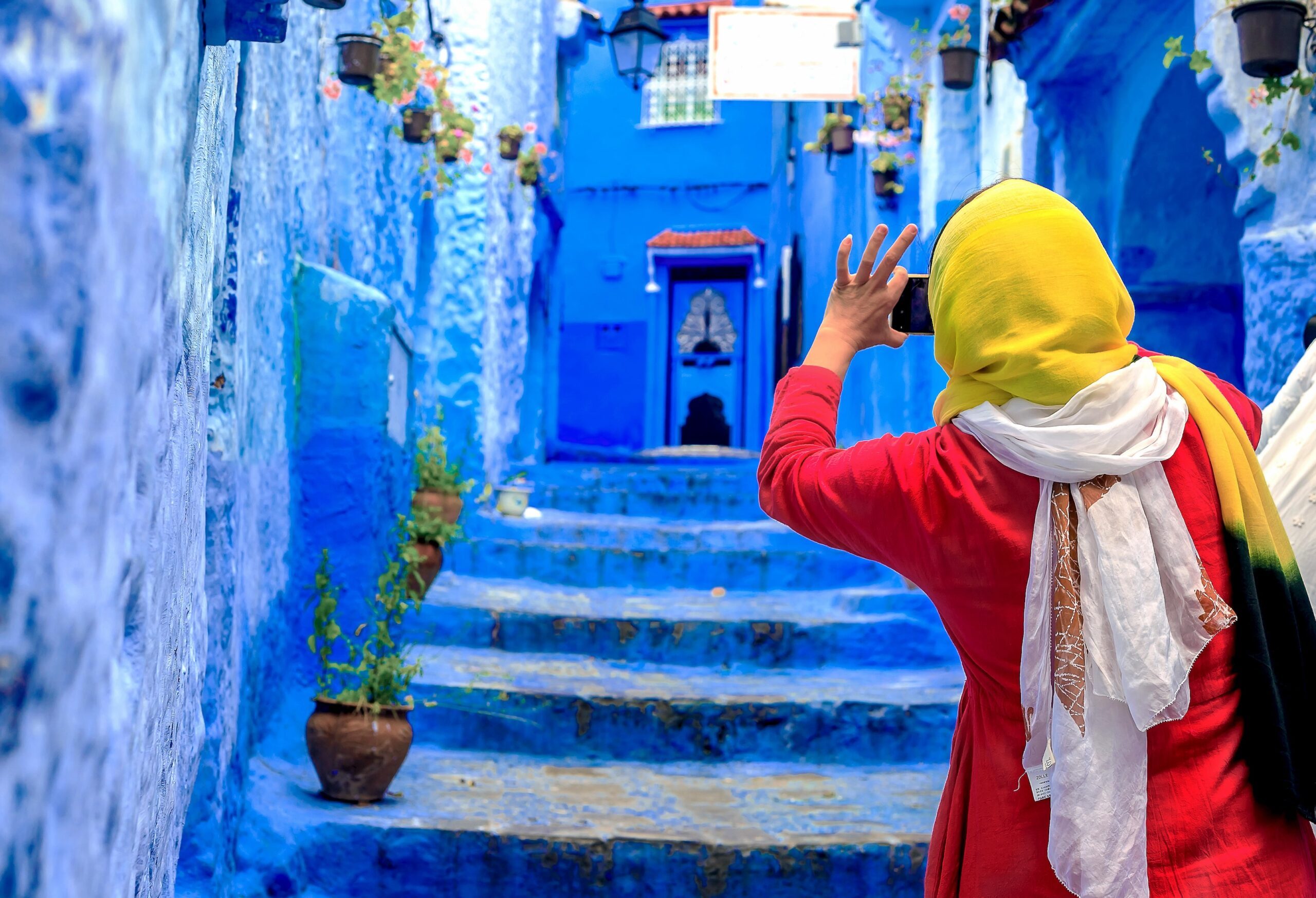 A tourist takes pictures in Chefchaouen, northern Morocco. The country's tourism startup culture is opening new markets beyond the traditional centres