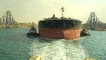 The MT Sounion being towed through Egypt's Suez Canal earlier this month after it was attacked in the Red Sea. Suez Canal revenues have dropped from $2.4bn to $1bn