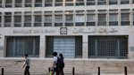 People walk past Lebanon's Central Bank building in Beirut. The IMF is calling for greater data transparency in the Lebanese economy