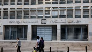 People walk past Lebanon's Central Bank building in Beirut. The IMF is calling for greater data transparency in the Lebanese economy
