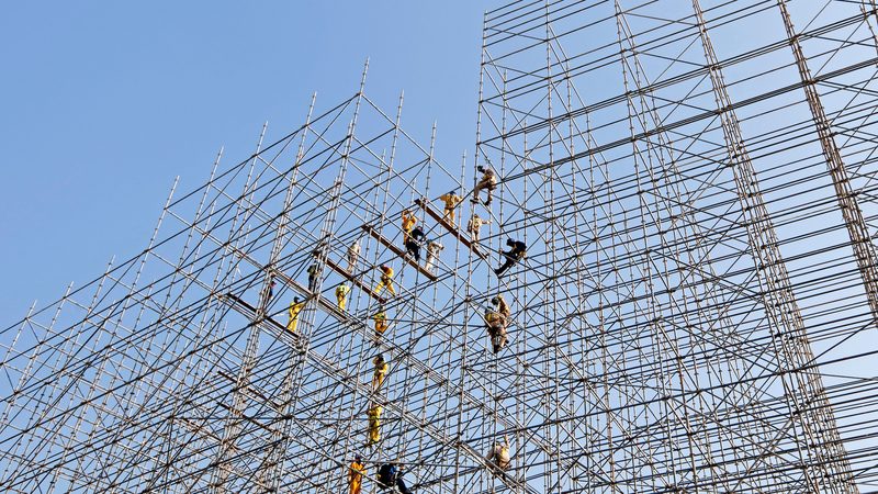 Construction workers erect scaffolding in Doha. Across the GCC, roads, railways, homes and hotels are being built
