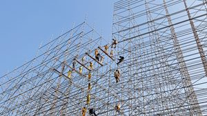 Construction workers erect scaffolding in Doha. Across the GCC, roads, railways, homes and hotels are being built