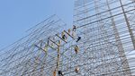 Construction workers erect scaffolding in Doha. Across the GCC, roads, railways, homes and hotels are being built