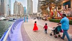 A family strolls in Dubai Marina, developed by Emaar. The company's shares are up 5.5% on the DFM this year
