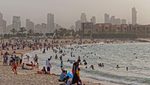 People enjoy Kuwait City's Marina beach. The IMF says Kuwait's public sector wages are around 40 percent higher than private sector wages