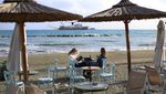 Two women relax in a waterfront cafe during the day in the Mediterranean port of Limassol. Cyprus, Tuesday, January 9, 2024. (Photo by Danil Shamkin/NurPhoto)NO USE FRANCE