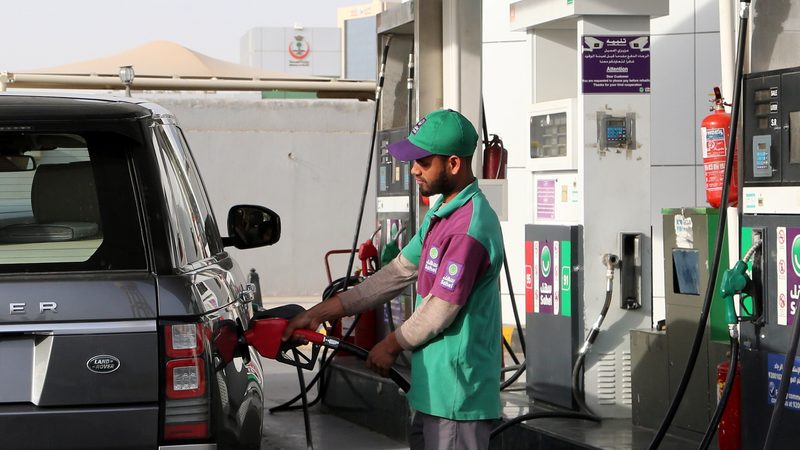 A worker fills a tank at a petrol station in Riyadh. The rise of renewable energy and electric vehicles are having an impact on oil demand