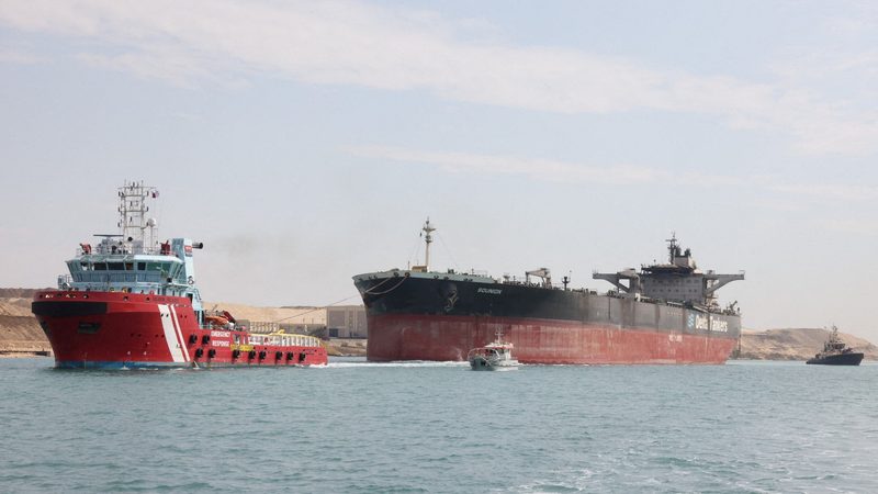 Tugboats help tow the Greek-registered MT Sounion, which was attacked by Yemen's Houthi militants last year in the Red Sea