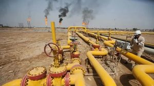 A worker checks an oil pipeline at Nahr Bin Umar oil field in Iraq