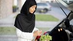 A woman in a headscarf loads groceries into the back of a car. Saudi consumer spending rose as shoppers stocked up ahead of Ramadan