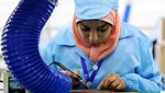 A woman assembles mobile phone parts at a factory run by Egyptian brand Sico. Foreign manufacturers including Samsung and Nokia have set up in Egypt