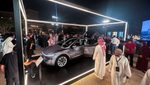 Visitors look at the Tesla Model Y during the opening of Tesla's first Saudi showroom, in Riyadh