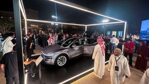 Visitors look at the Tesla Model Y during the opening of Tesla's first Saudi showroom, in Riyadh