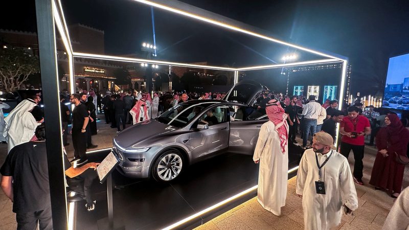 Visitors look at the Tesla Model Y during the opening of Tesla's first Saudi showroom, in Riyadh