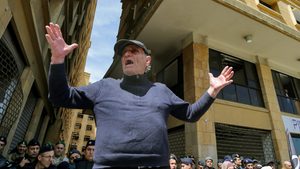 A Lebanese bank customer protests outside the Ministry of Economy in Beirut. Depositors have faced cash-withdrawal restrictions since 2019