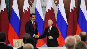 Qatar's Emir Sheikh Tamim Bin Hamad Al Thani and Russia's President Vladimir Putin attend a signing ceremony following their talks at the Kremlin in Moscow on April 17, 2025
